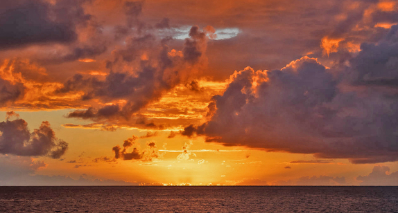 Dramatic sunset over the ocean horizon.