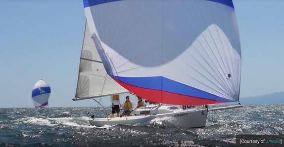 Sailboat racing on open ocean water.