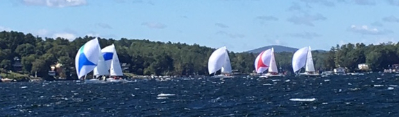 Sailboats racing on a windy lake.