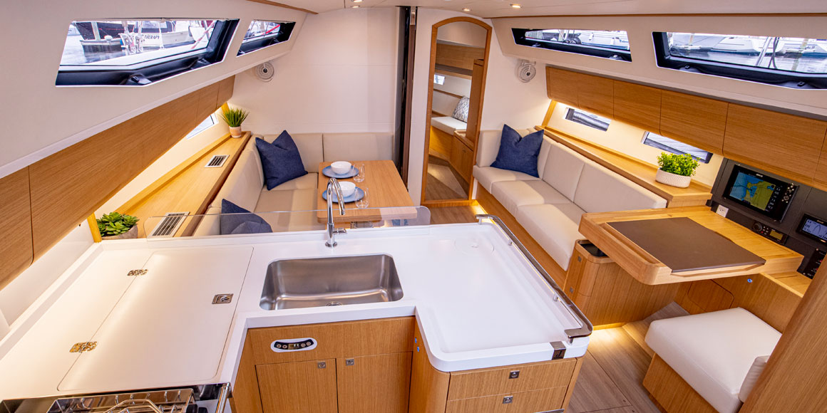 Cozy yacht interior with dining and kitchen area, neutral tones, and modern design.