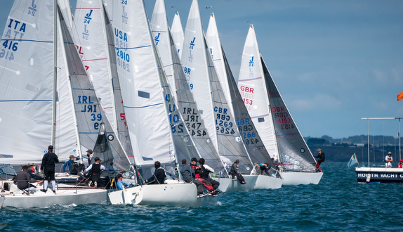 Sailboats racing in a competitive regatta.