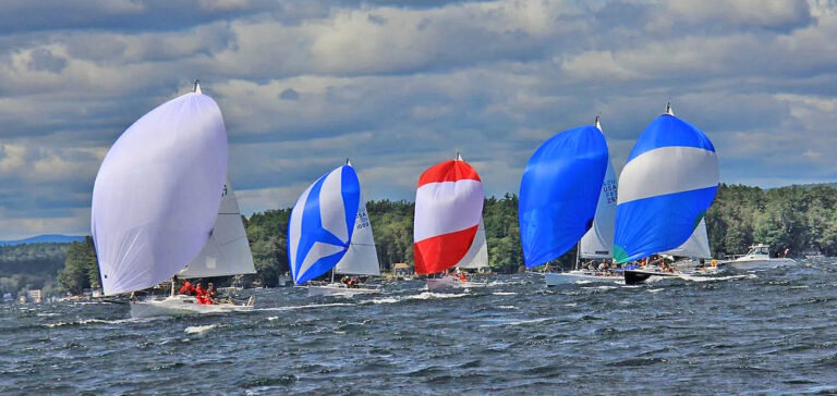 Colorful sailboats racing on a windy day.