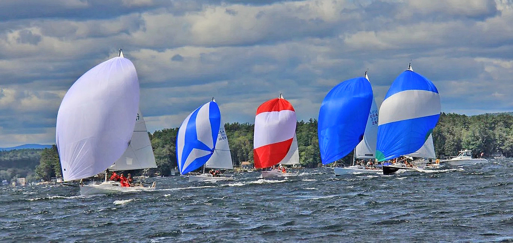 Colorful sailboats racing on a windy day.