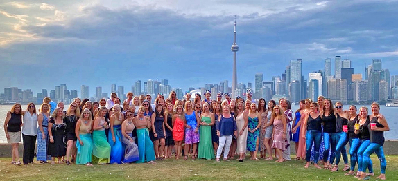 Group photo with city skyline background.