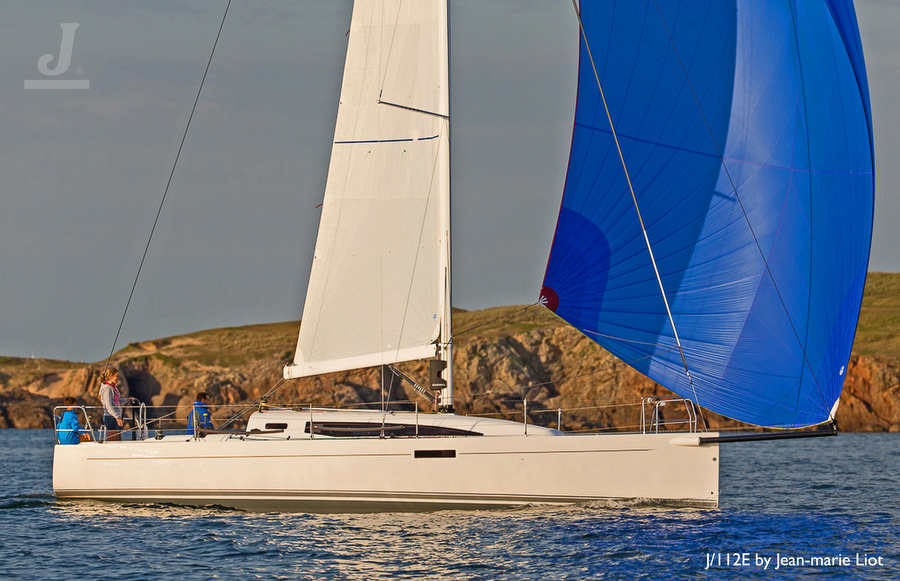 Sailboat on water with blue spinnaker.