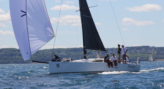 Sailboat with crew on open water.