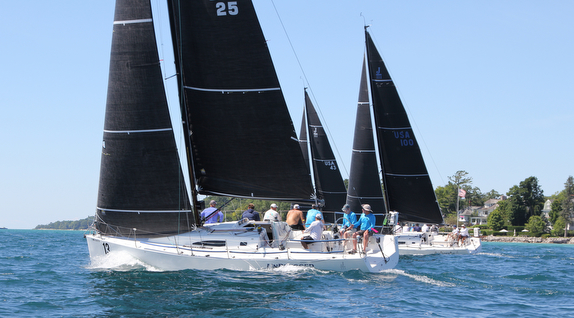 Sailboats racing on a sunny day.