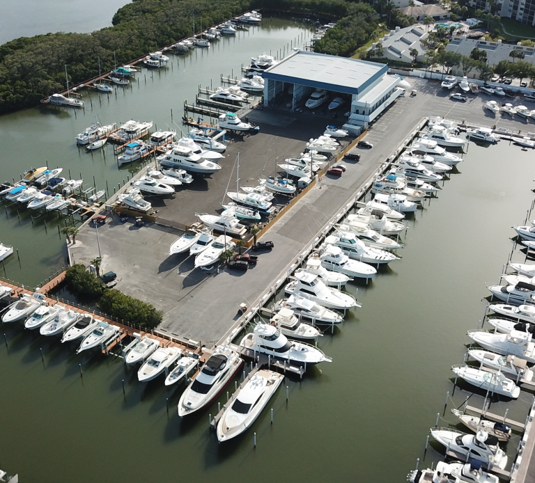 Aerial view of a marina filled with boats and yachts docked along piers.