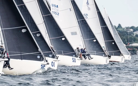 Sailboats racing on open water.