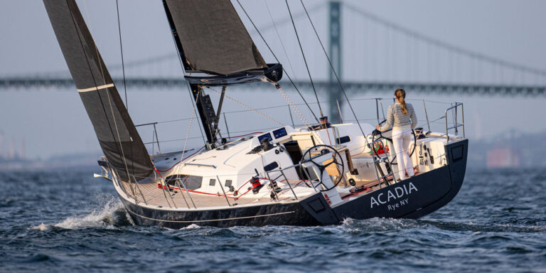 Sailboat named Acadia on the water.