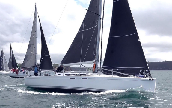 Sailboats racing on a cloudy day.