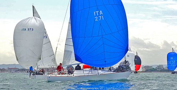 Sailboats racing with colorful spinnakers.
