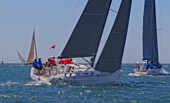 Sailboats racing on a sunny day.
