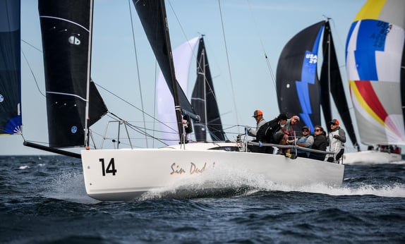Sailboats racing in open sea competition.