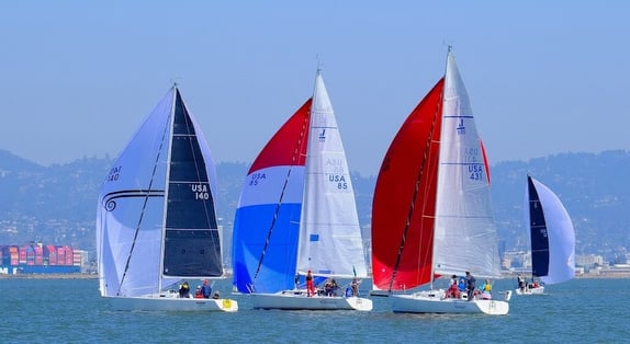 Sailboats racing on a clear day.