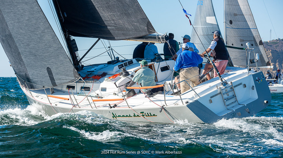Sailboat racing with crew on board.