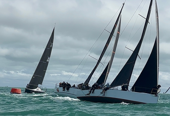 Sailboats racing on a windy day.