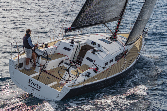 Sailboat on water with person steering.