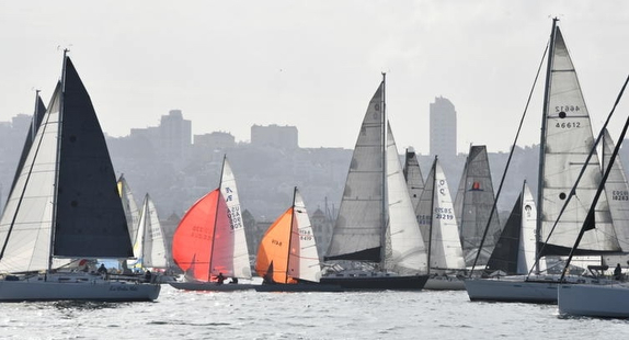 Sailboats racing on a cloudy day.