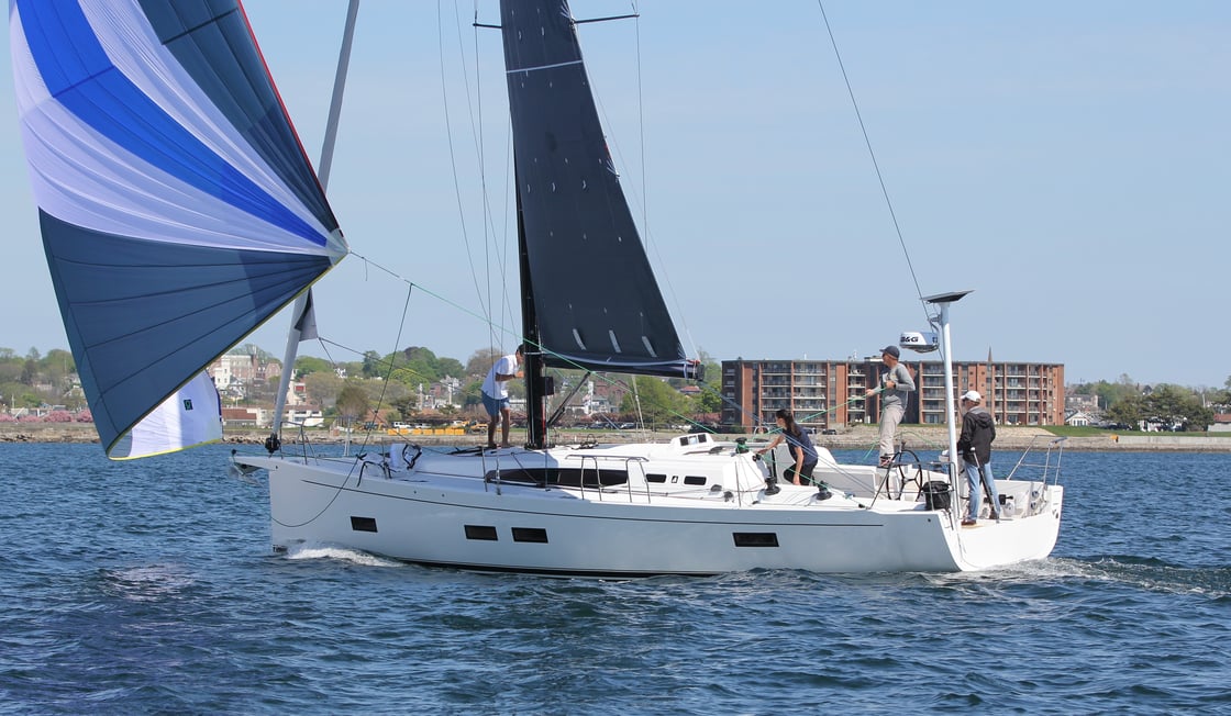 Sailboat with crew on open water.