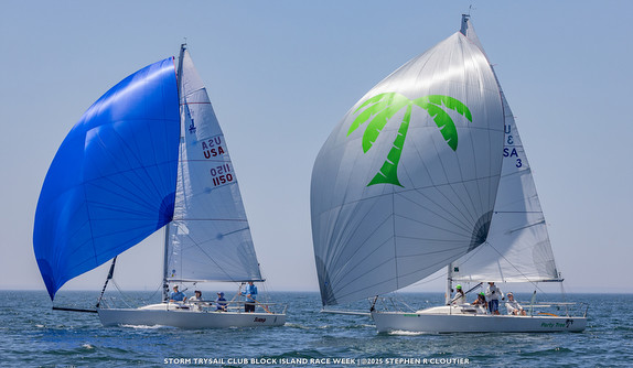 Two sailboats racing with colorful spinnakers.