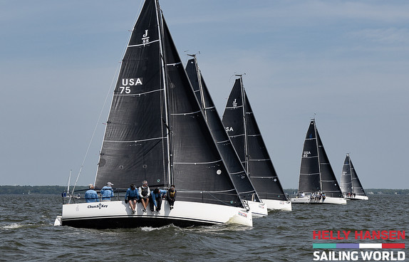Sailboats racing on open water.