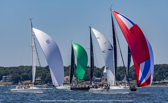 Sailboats racing on open water.