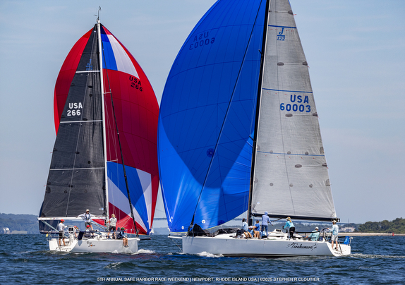Two sailboats racing with colorful spinnakers.