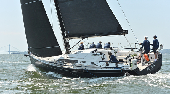 Sailboat with crew navigating the water.