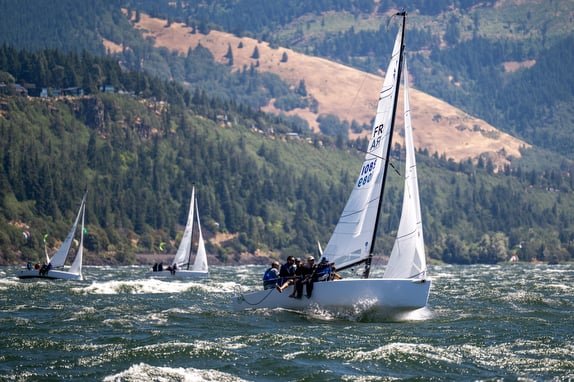 Sailboats racing on a windy mountain lake.
