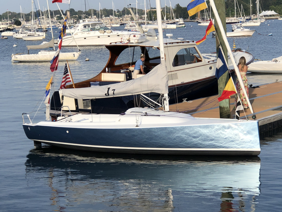 Small sailboat docked with colorful flags.