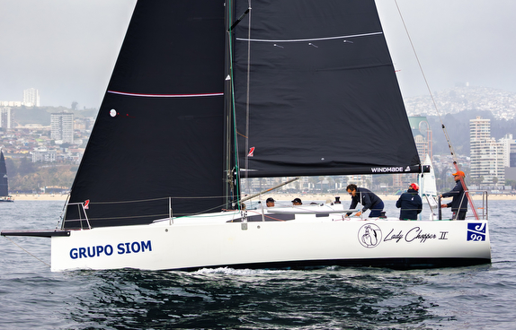 Sailboat with crew on water.