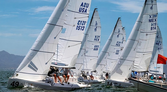 Sailboats racing in the ocean.