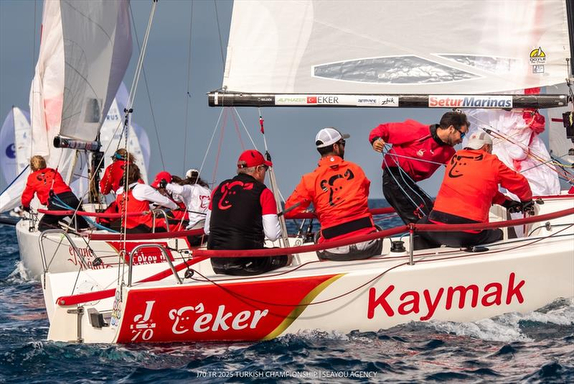 Sailboats racing in a competitive regatta.
